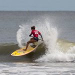 Wave surfing on stand up paddleboard at a West Cork beach in Ireland
