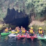 group kayaking to some caves in ireland